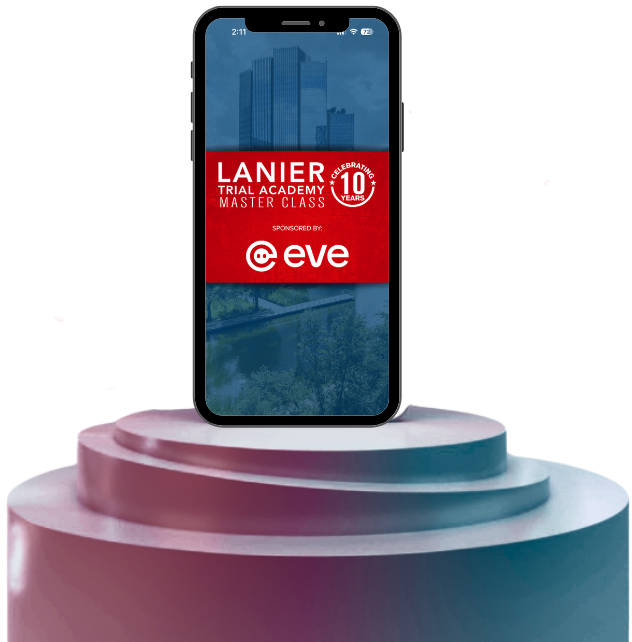 Alt text: A smartphone displayed upright on a tiered pedestal against a dark background, showing a promotional screen that reads “Lanier Trial Academy Master Class” with a red banner and a “10 Years” badge, overlaid on a faint cityscape image.